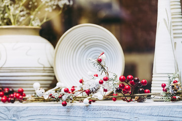 Décor de table de fêtes avec céramique blanche et branchage blanc et rouge