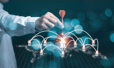 Businessman hand holding and trowing red dart to icon of banking and connection path. Investment...