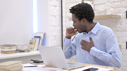 Sick African Man having Coughing while working 
