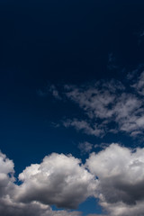 Dark blue sky with clearly white clouds.