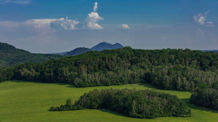 Summer landscape with few peaks and on one of them is castle (Bezdez).	
