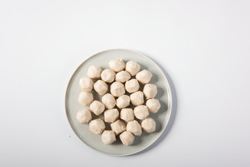 Meatballs made of fish are in delicate plates, isolated in white background