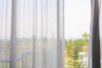 window curtain with green garden abstract blur background
