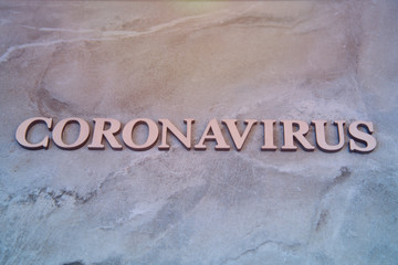 coronavirus outbreak word written on wooden letters.