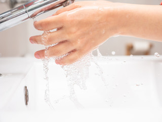 hands washing on a sink