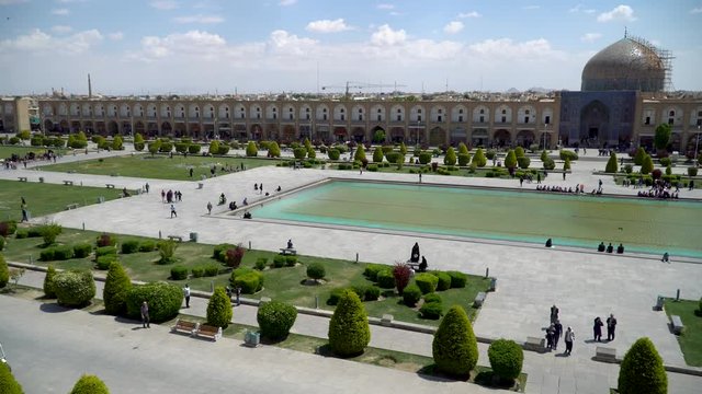 Isfahan, Iran - May 2019: Tourists and Iranian people in Isfahan Naqsh-e Jahan Square also called Imam Square