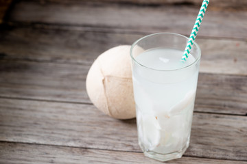 Fresh coconut juice in a glass with coconut white meat isolated on white