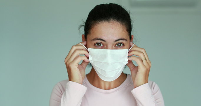 Woman Putting On Surgical Mask For Corona Virus Prevention