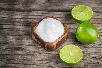 Baking soda and lemon on wooden background space for text