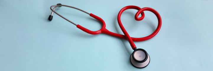 Red stethoscope with heart on blue modern background. Medical insurance concept - obrazy, fototapety, plakaty