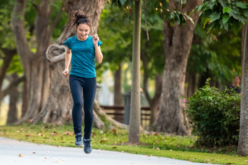 Beautiful Asian women are jogging in the park.