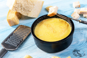 Swiss fondue melted cheese served with bread