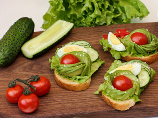  healthy breakfast sandwiches with avocado, tomato and cucumber. selective focus. healthy lifestyle concept. low carb diet.