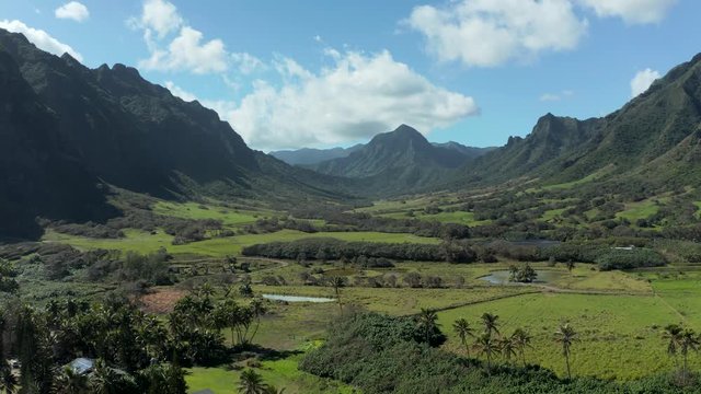 Aerial drone pans across the broad panorama of the Kualoa or Ka'a'awa valley near Kaneohe on Oahu used in jurassic films