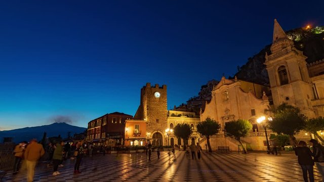 Timelapse view of Taormina main square at night with mount Etna in the background (Sicily)