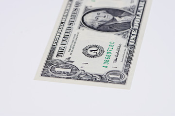 part of one Dollar bill on white surface with copy space