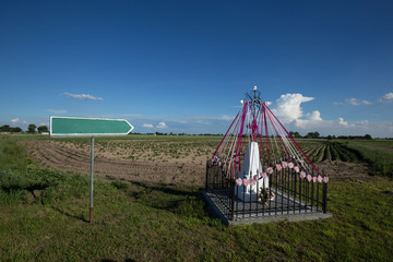 Chapel in the field with a signpost