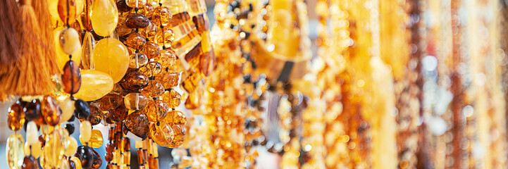 Amber beads in a jewelry store window. Jewelry design. Amber background of beads.