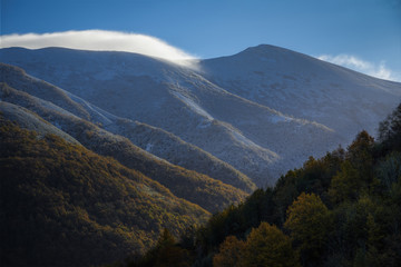 Fototapeta premium Frost covered mountains and misty peaks