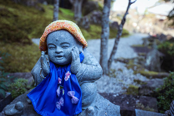 Fototapeta na wymiar Buddha in cap Statue in Itsukushima Island, Japan