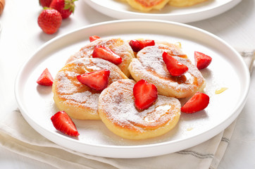 Homemade pancakes with cottage cheese and strawberry slices