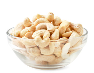 Cashew nuts in a glass plate on a white background. Isolated