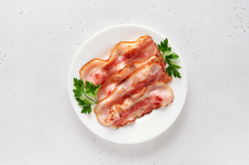 Fried bacon slices on plate