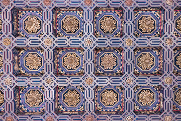 Blue and gold colored figures on the roof of a castle