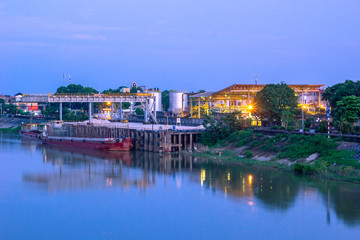 Fototapeta na wymiar Oil Refinery Factory Near The River In Small Hometown of Vietnam