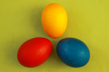 Fototapeta na wymiar Primary colors Easter eggs green background