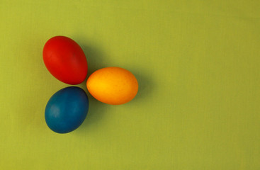 Primary colors Easter eggs green background