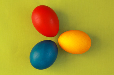 Primary colors Easter eggs green background