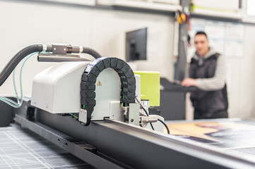 Technician works on large CNC computer numerical control cutting machine
