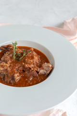 Lamb stew with aromatic herbs seen from above