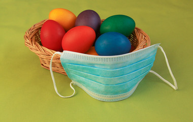 Colored eggs in basket medical mask Easter 2020