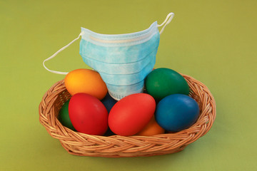 Colored eggs in basket medical mask Easter 2020
