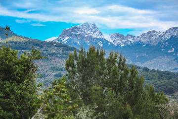 view of Serra de Tramuntana with snow capped mountains in Mallorca, Spain