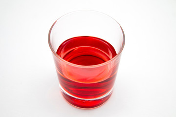 red drink in a glass with white background
