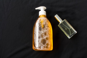 Bottle of liquid soap with a pump . perfume bottle on black background