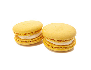 two yellow macaroons on a white isolated background