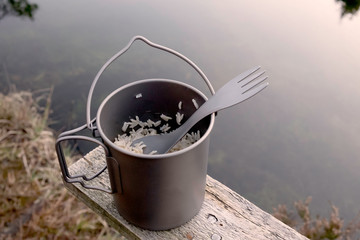 Rice in a titanium pot on the nature.