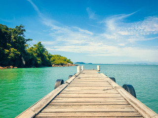 bridge going to the ocean. on the background of the mountain. pier in the middle