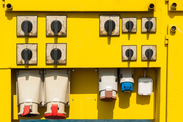 Yellow power supply switch box in the harbor