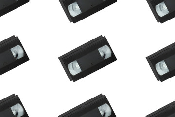 Seamless pattern with retro vhs tapes flat lay isolated on white background top view. Creative fashion design in minimal retro 80-s style. Film, tv concept. Web banner template. Stock photo.