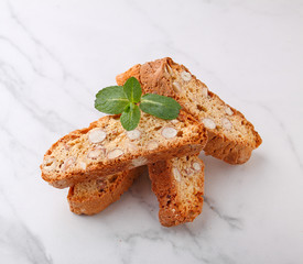 Biscotti with nuts on a marble background decorated with leaves mint. selective focus
