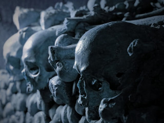 Human skulls and bones in a crypt, concept of death