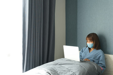 Woman in quarantine for Coronavirus wearing protective mask and smart working