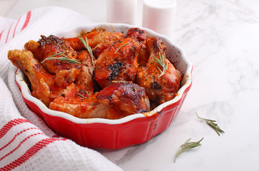 Baked chicken in tomato sauce on the marble background