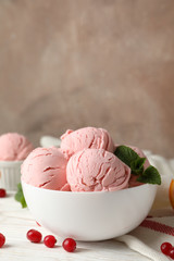 Bowls with ice cream balls on white wooden table, close up