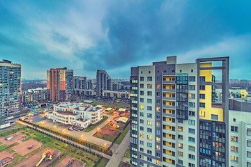 Obraz premium New modern residential buildings with lit windows